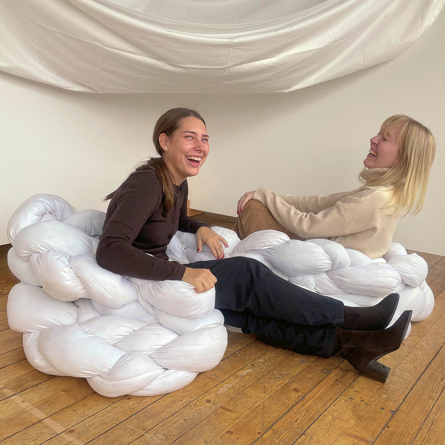 Two women in armchair. Photo. 